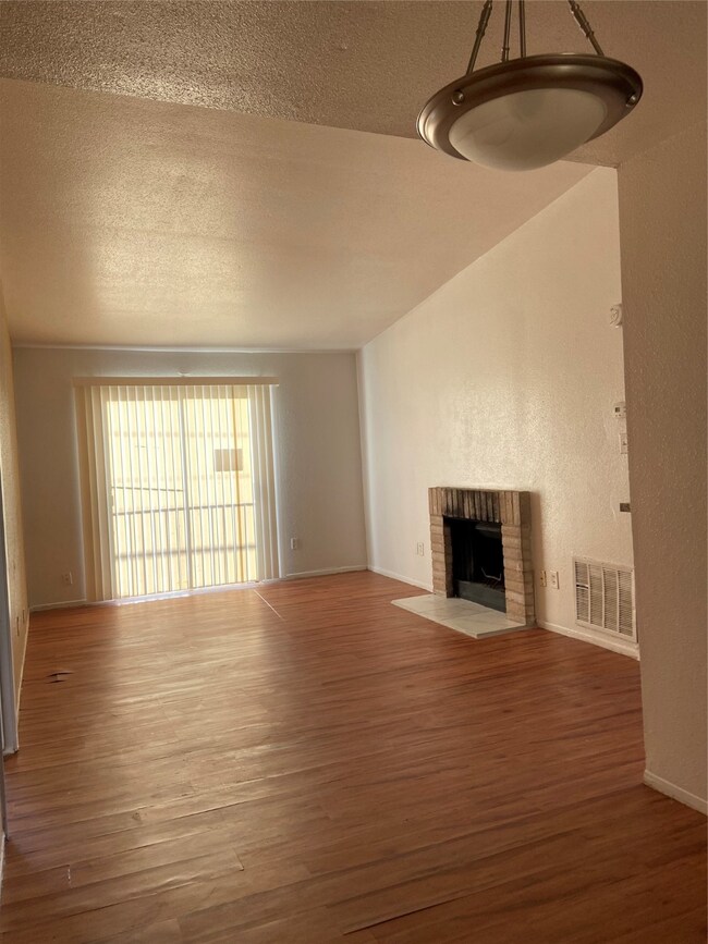 LIVING AREA W/ VAULTED CEILINGS AND FIREPLACE~