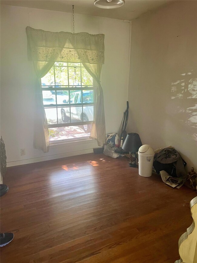Unfurnished room with dark wood-type flooring