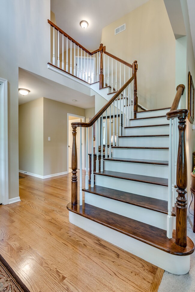 Soaring foyer is flanked by the living room.