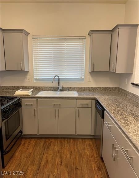 Kitchen featuring dark wood finished floors, stainless steel appliances, and plenty of natural light