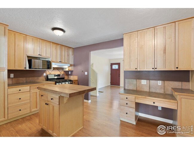 There is great prep space in the kitchen with the food grade butcher's block island and cabinets and counters on all sides. Stainless steel appliances including a gas cook top.