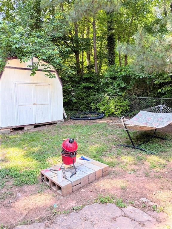 View of green lawn featuring a storage shed and an