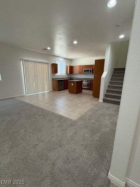Kitchen featuring open floor plan, a kitchen islan