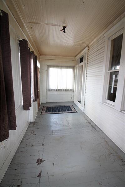 Enclosed front porch is a great additional space f