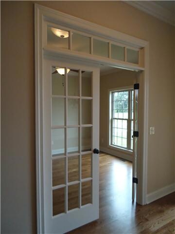 Off the foyer is an office with french entry doors and transom window. The gleaming hardwood, ceiling fan lighting and doubles windows make this a welcoming place to work.