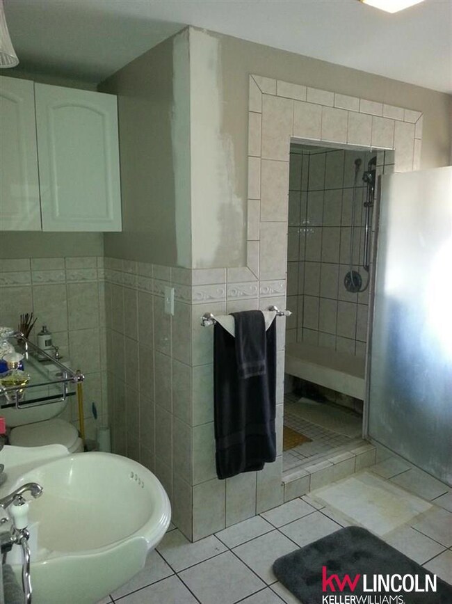 Custom tiled walk in shower w/laundry.