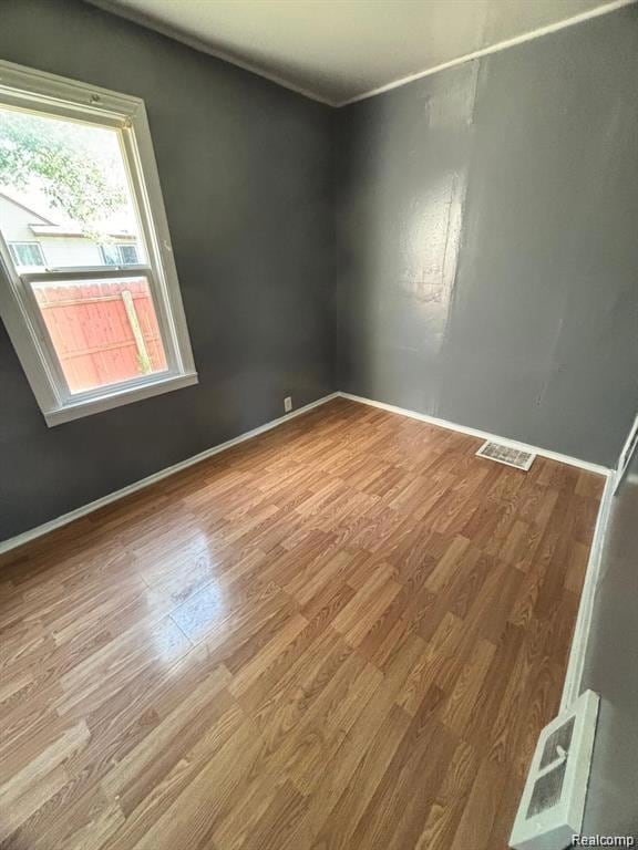 Empty room featuring baseboards and wood finished floors