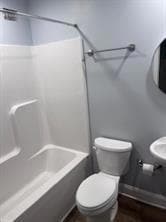 Bathroom featuring shower / bath combination and toilet