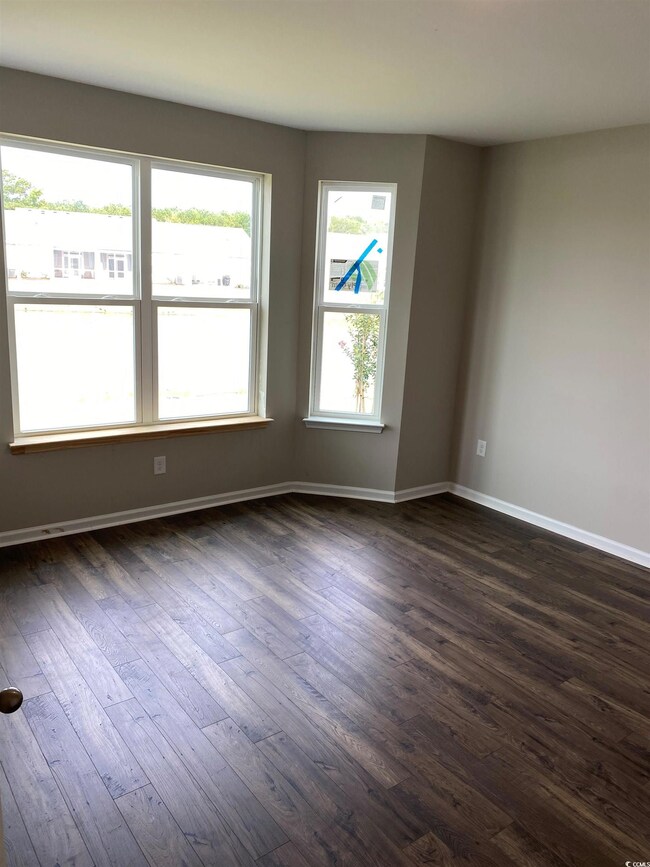Unfurnished room featuring dark wood-type flooring