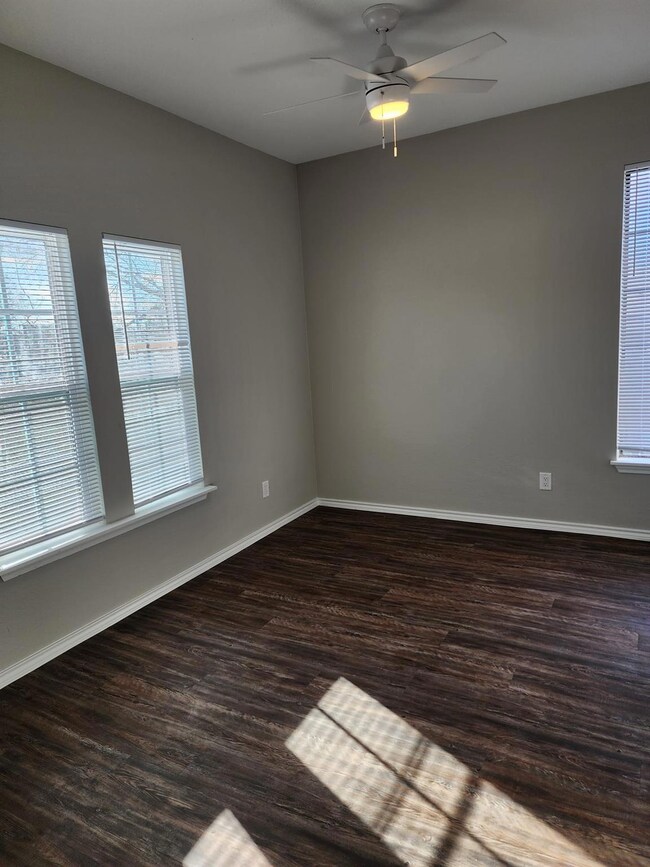 Spare room featuring baseboards, wood finished fl