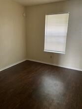 Empty room featuring baseboards