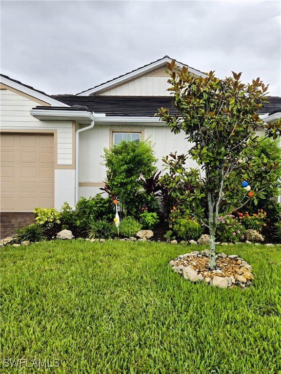 View of property exterior featuring a lawn and boa