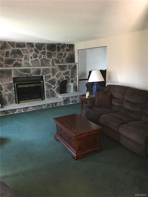 Living room w/ beautiful wood burning fireplace an
