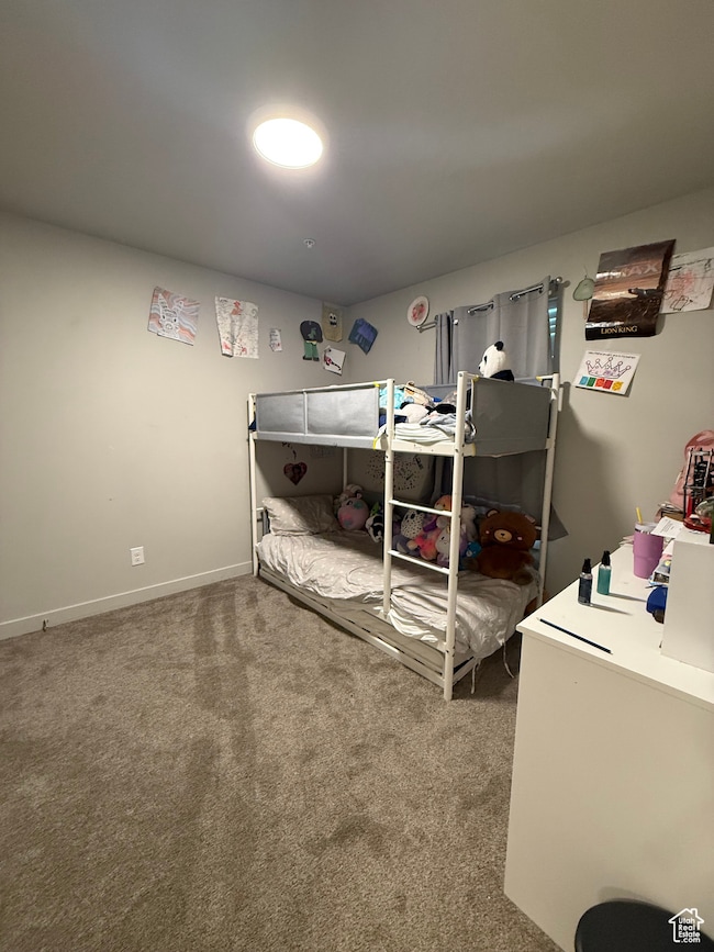 Bedroom with light carpet and baseboards