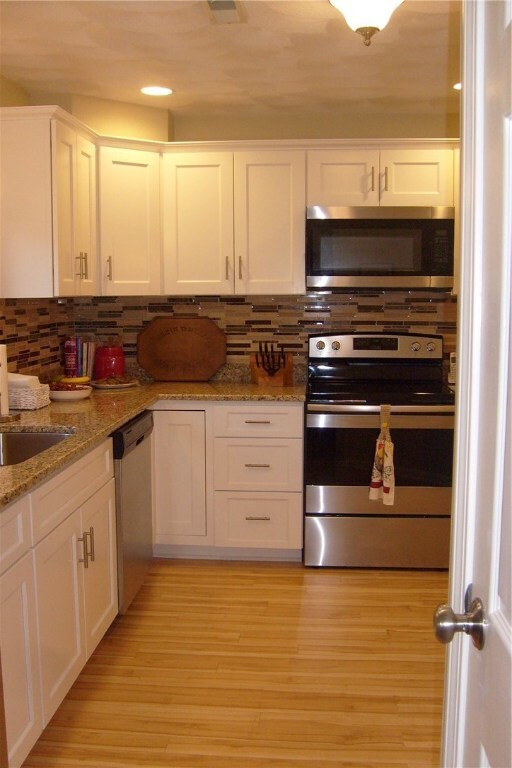 Newer kitchen cabinetry, granite and stainless appliances