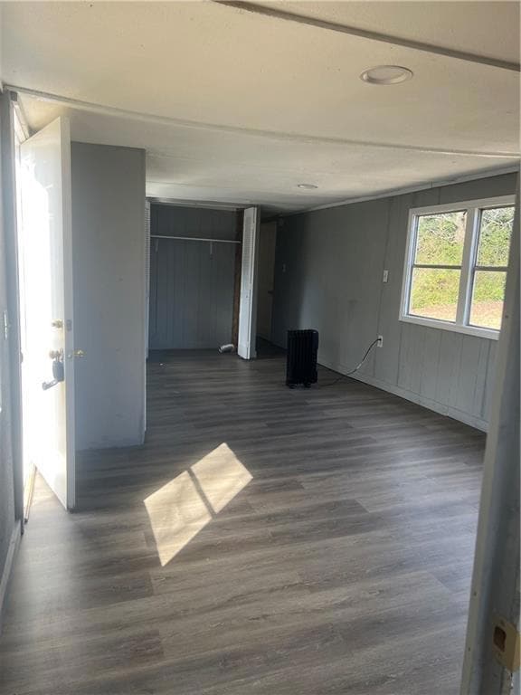 Unfurnished room featuring dark wood-style floors
