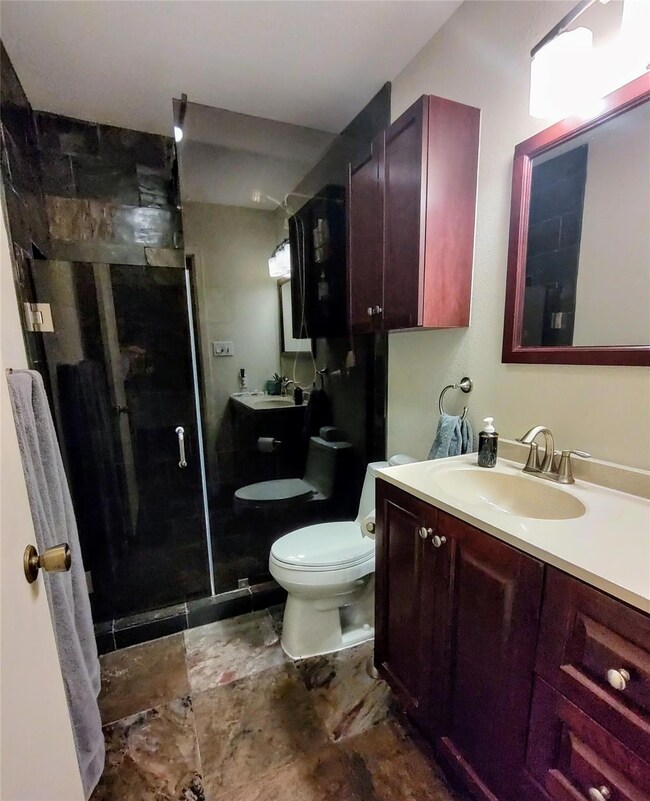 Full bathroom featuring a shower stall, vanity, a
