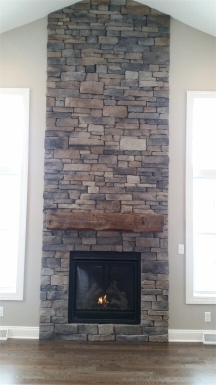 Floor to ceiling gas stone fireplace