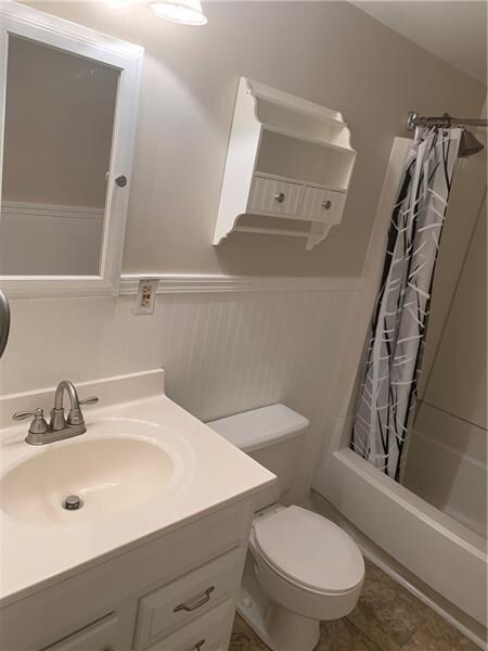 The fresh and bright full bathroom has a new toile