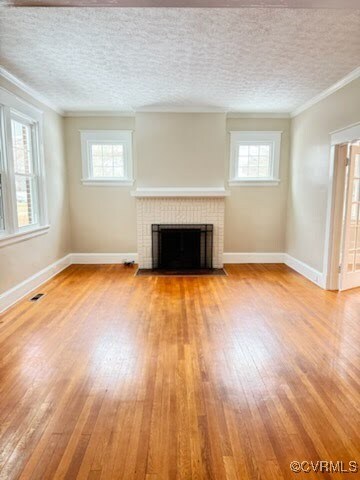 Unfurnished living room featuring light hardwood /