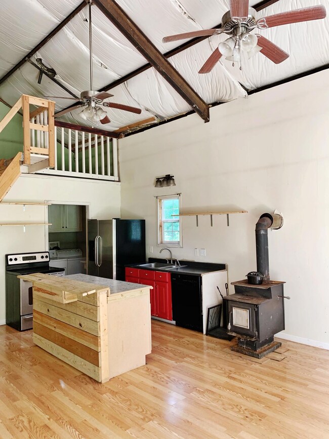 Kitchen with Island, Stainless appliances and wood stove