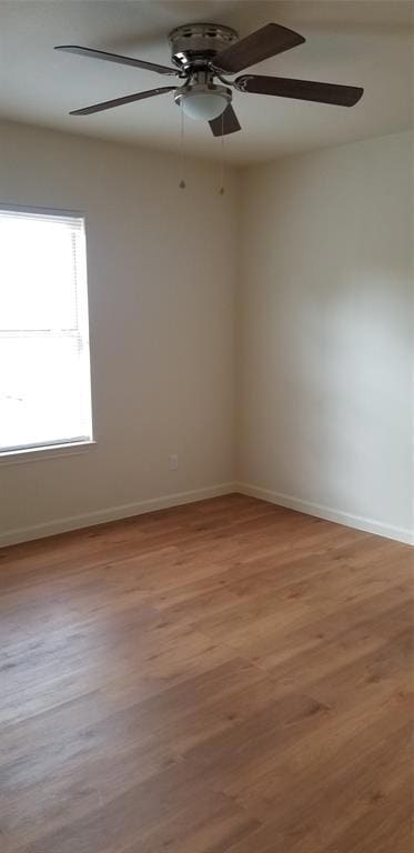 Unfurnished room with baseboards, a ceiling fan, 