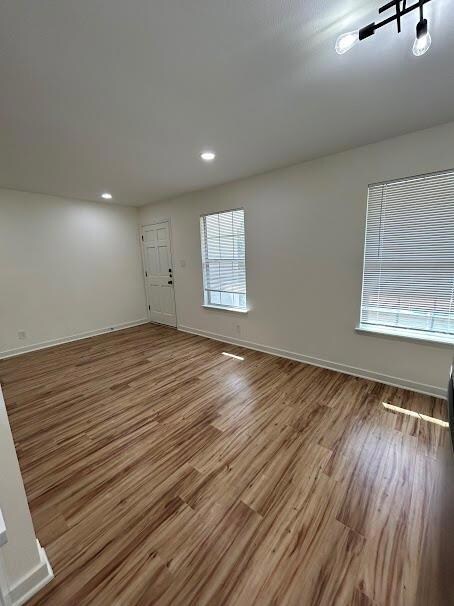 Spare room with wood finished floors and recessed
