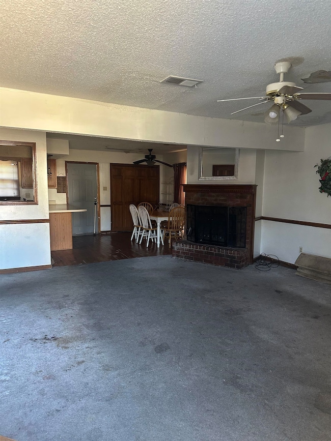 Unfurnished living room with a textured ceiling, d
