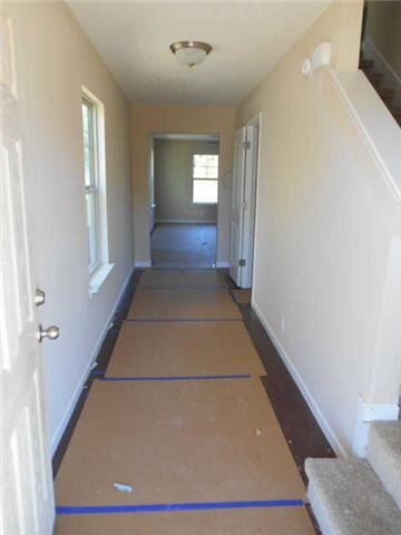 Full Foyer w/ hardwood floors (under the protective cardboard) powder room, great room, dining room & kitchen with hardwood floors