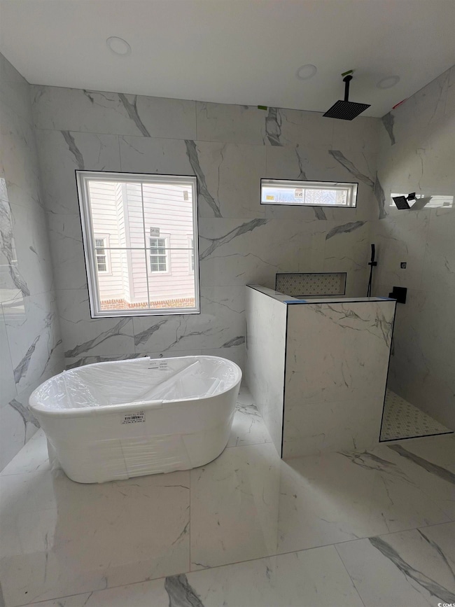 Full bathroom featuring stone wall