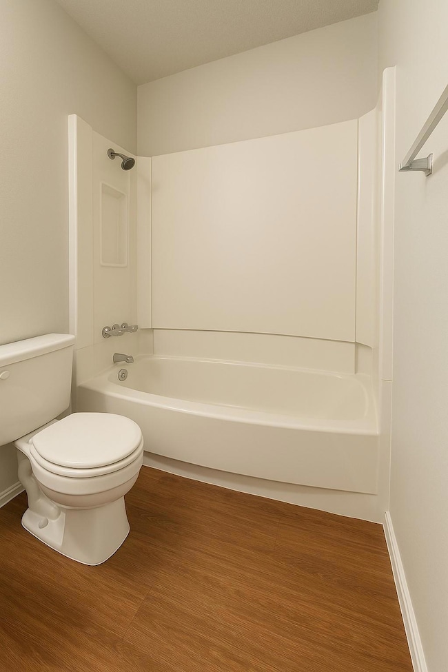 Full bath with shower / tub combination and wood 