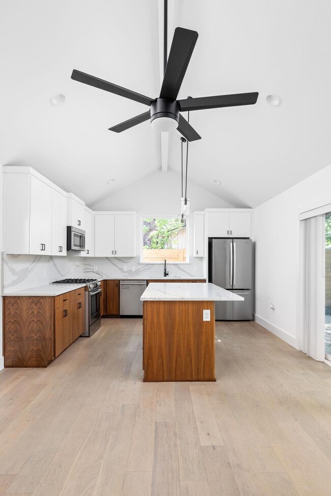 Kitchen featuring stainless steel appliances, lig
