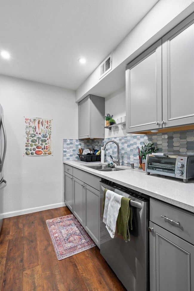 Kitchen featuring tasteful backsplash, visible ve