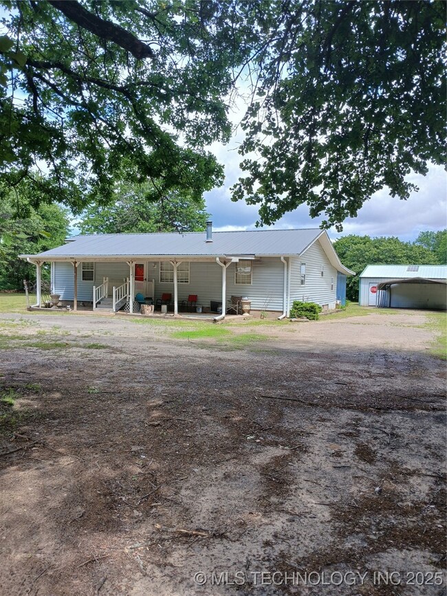 View of front of property with a porch, driveway,