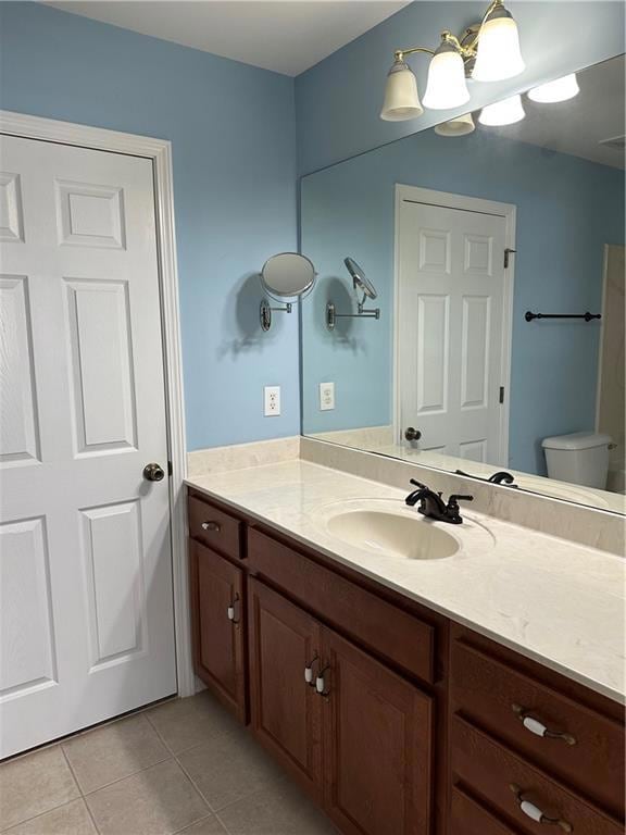 Bathroom with light tile patterned floors and vanity