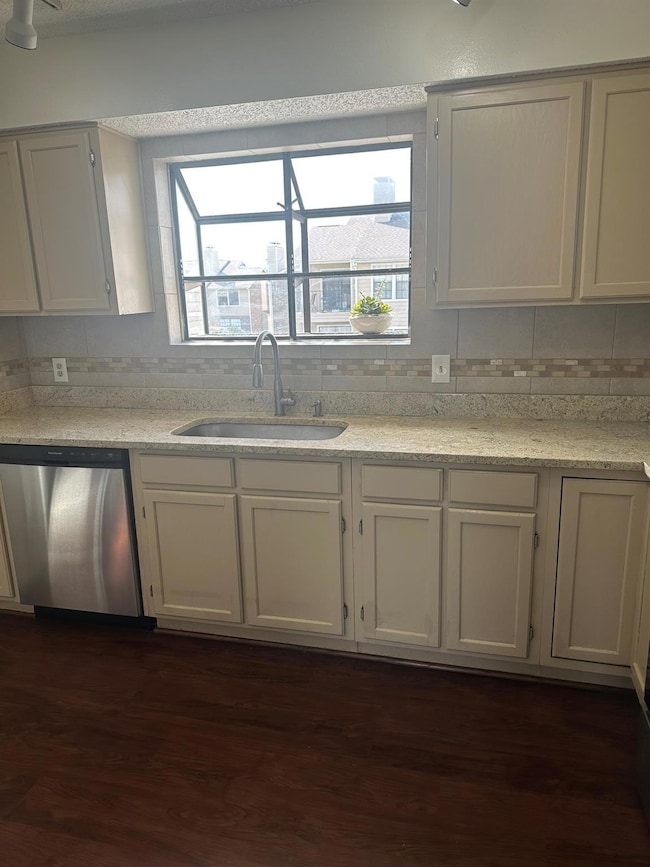 Kitchen with decorative backsplash, a sink, and di