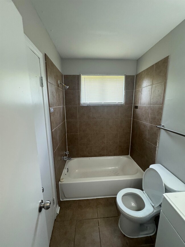 Bathroom with tile patterned floors, vanity, and tub / shower combination