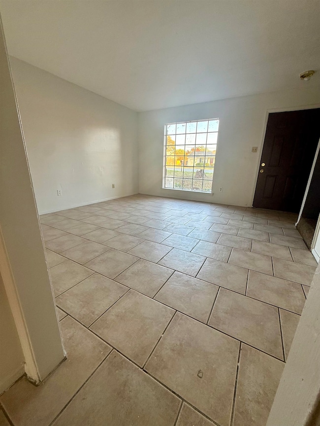 Empty room with light tile patterned floors