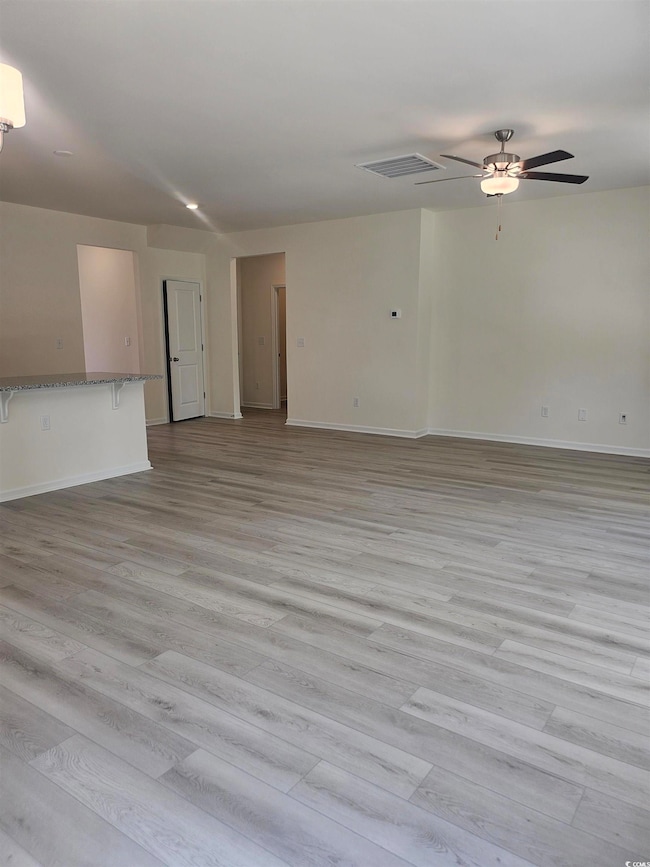 Unfurnished living room with LVPML floors and ceiling fan Please note photos are of similar home plan, colors and options vary from home