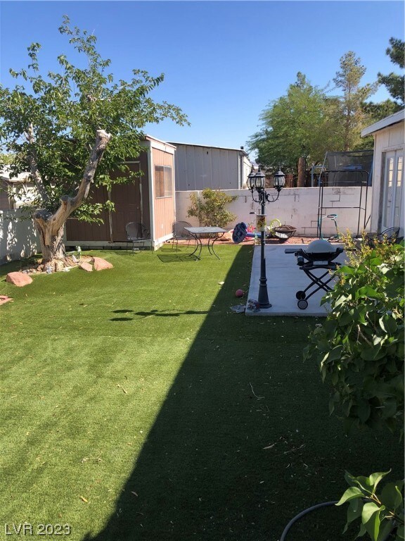 Side to back yard with storage shed in corner