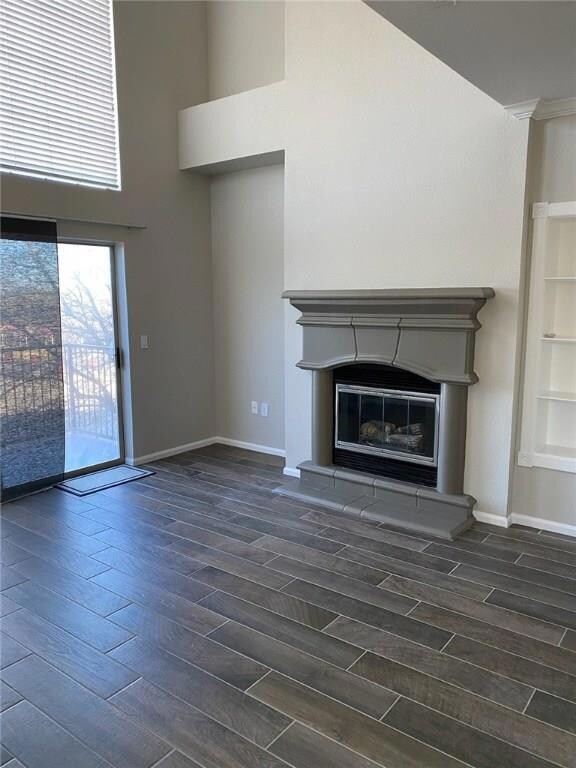Unfurnished living room with a glass covered fire