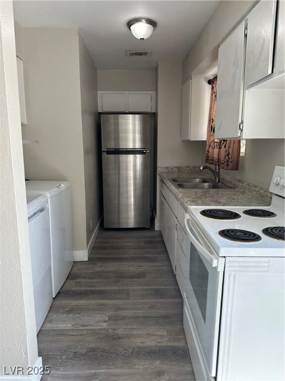 Kitchen featuring stove, freestanding refrigerator