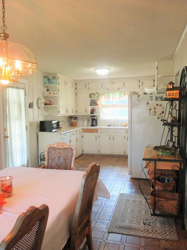 Large kitchen and dining room with patio door