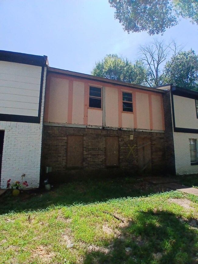 Rear view of house with brick siding