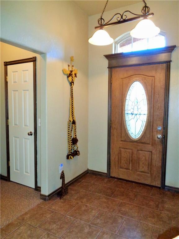 Entry with elegant lighting. Coat closet to the le