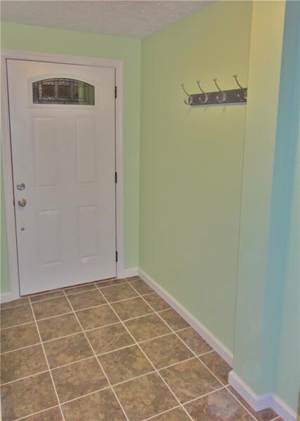 Entry with new ceramic tile floors, fresh paint al