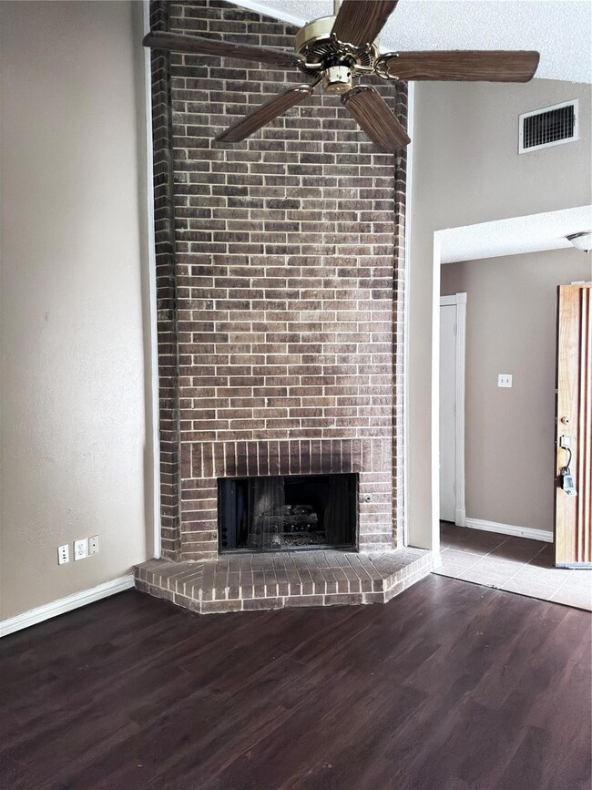 Unfurnished living room featuring dark hardwood / 