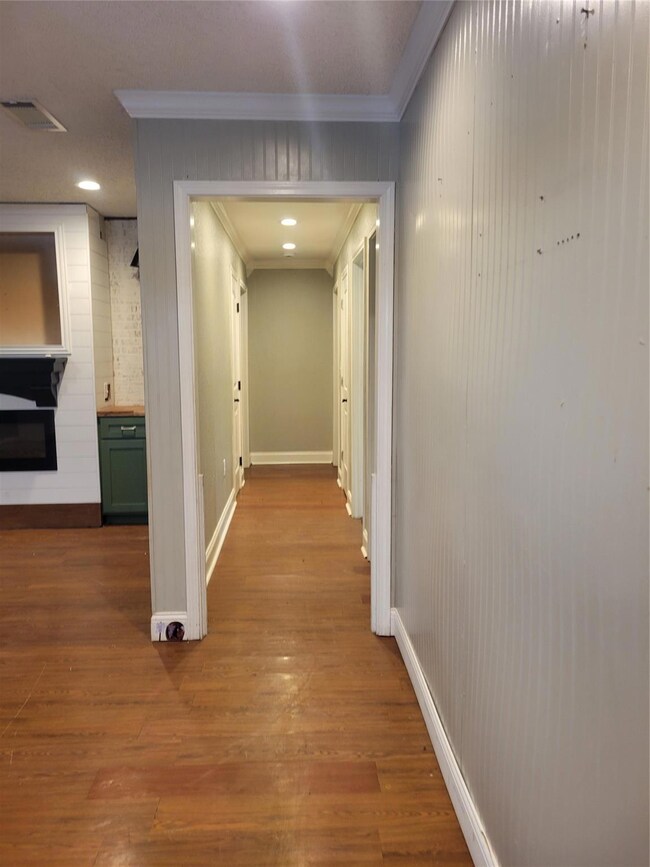 Corridor with light hardwood / wood-style floors a