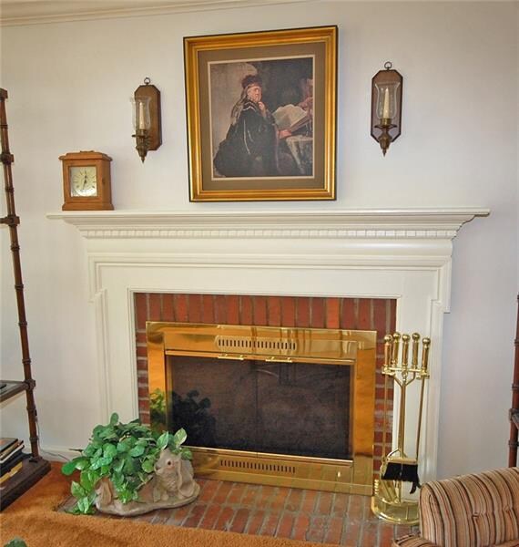 Log burning fireplace with beautiful wood mantel a