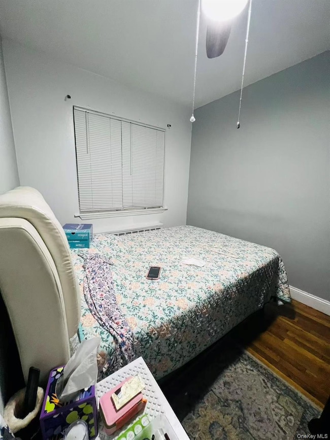 Bedroom with wood finished floors and a ceiling fan